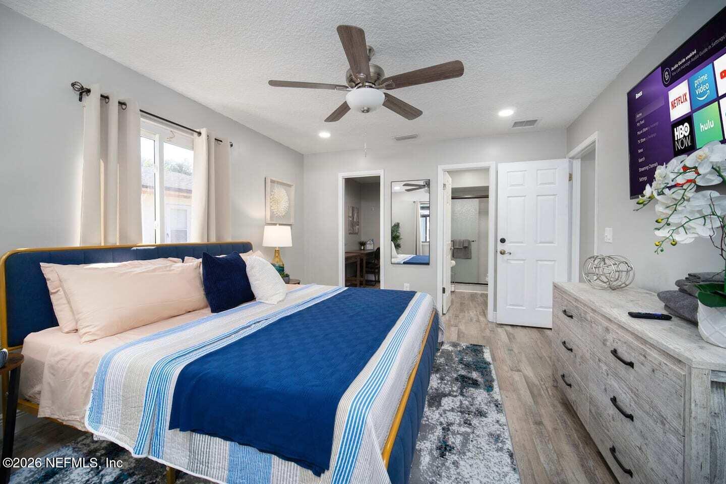 11613 Lake Ride Drive Jacksonville, FL 32223 - Photo 28 of 42 a bed room with a bed and a television