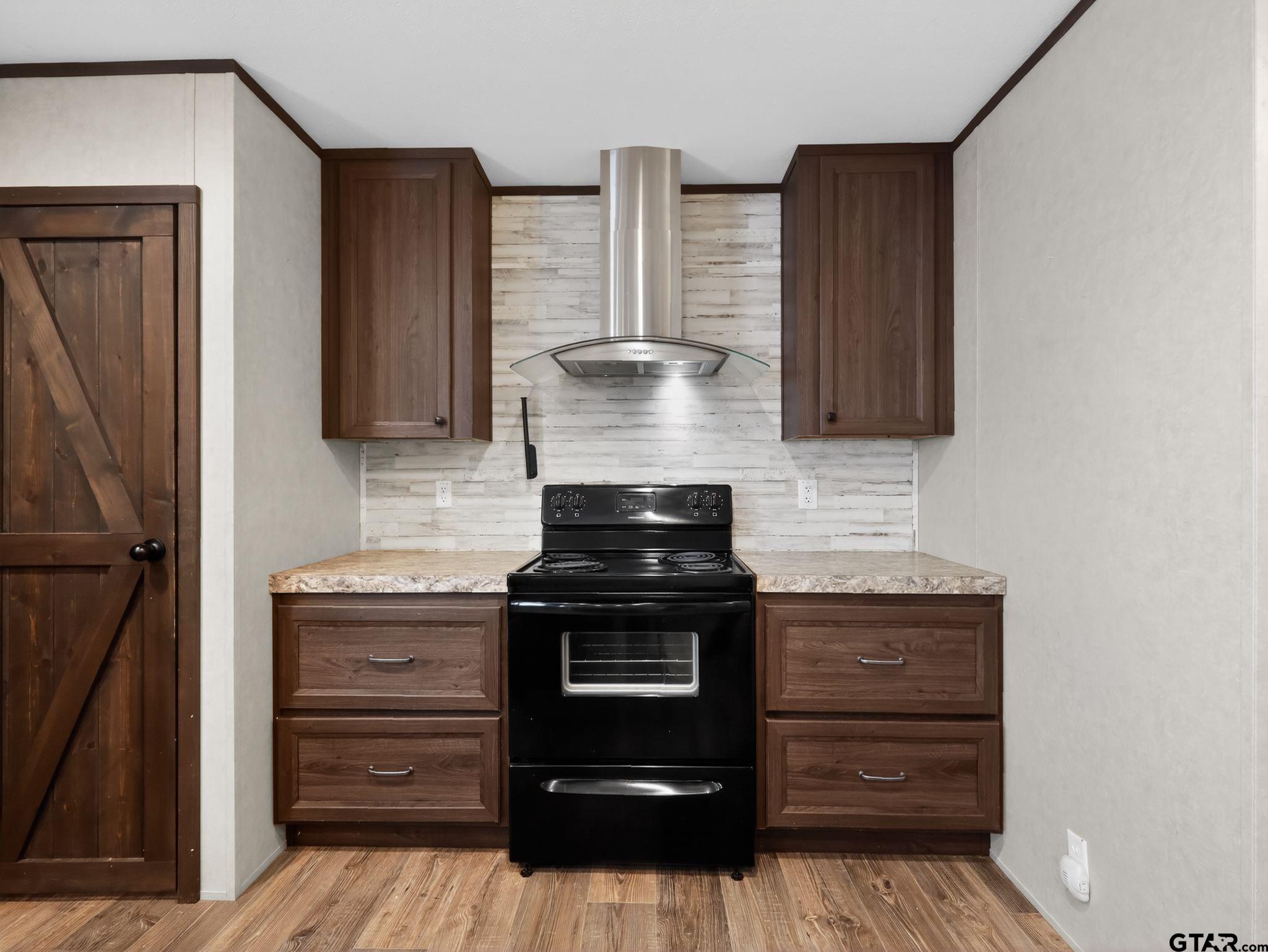 149 Running Bear Quitman, TX 75783 - Photo 13 of 31 a kitchen with a stove and a cabinet