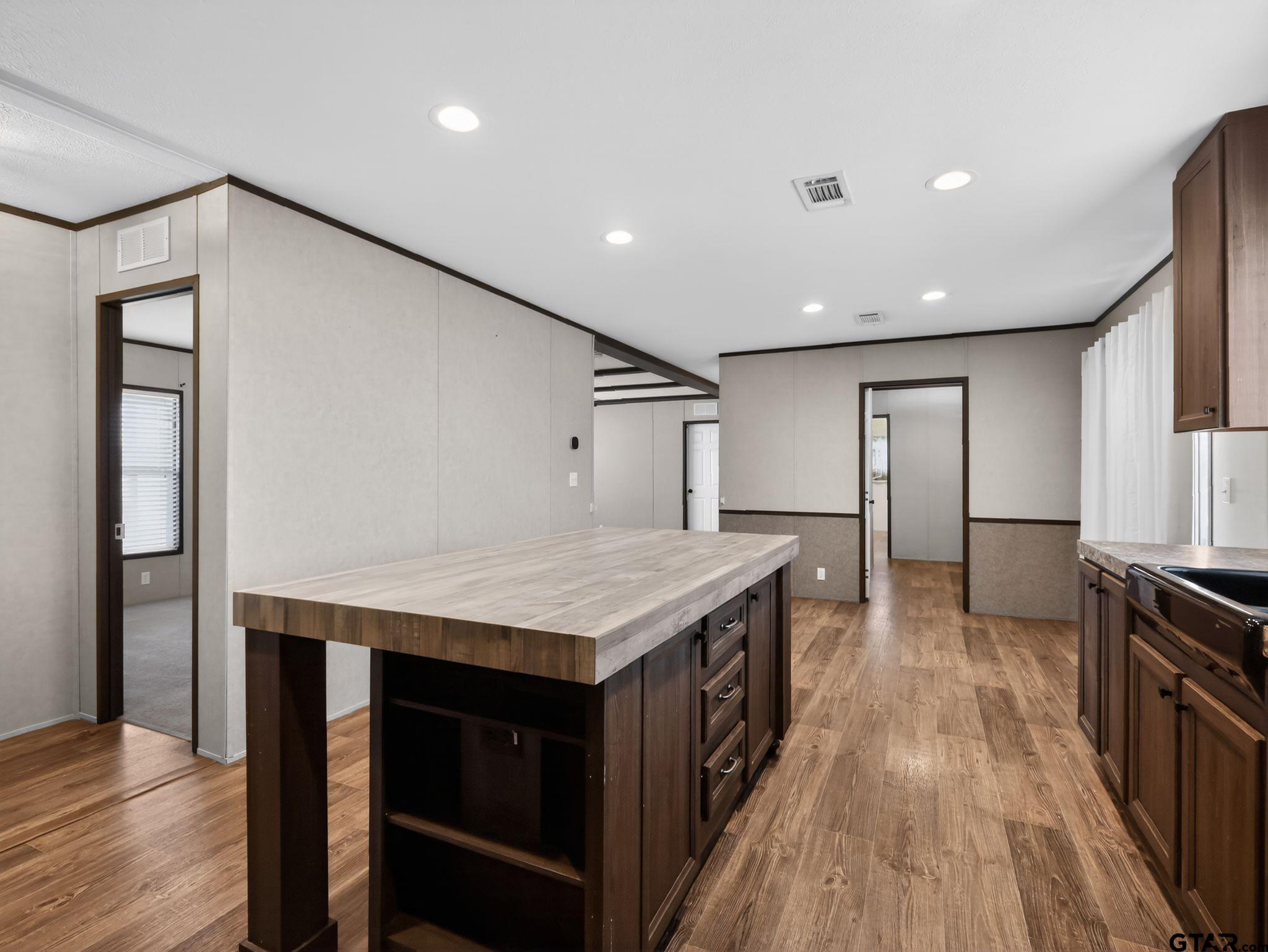 149 Running Bear Quitman, TX 75783 - Photo 16 of 31 a kitchen with kitchen island a stove and a refrigerator