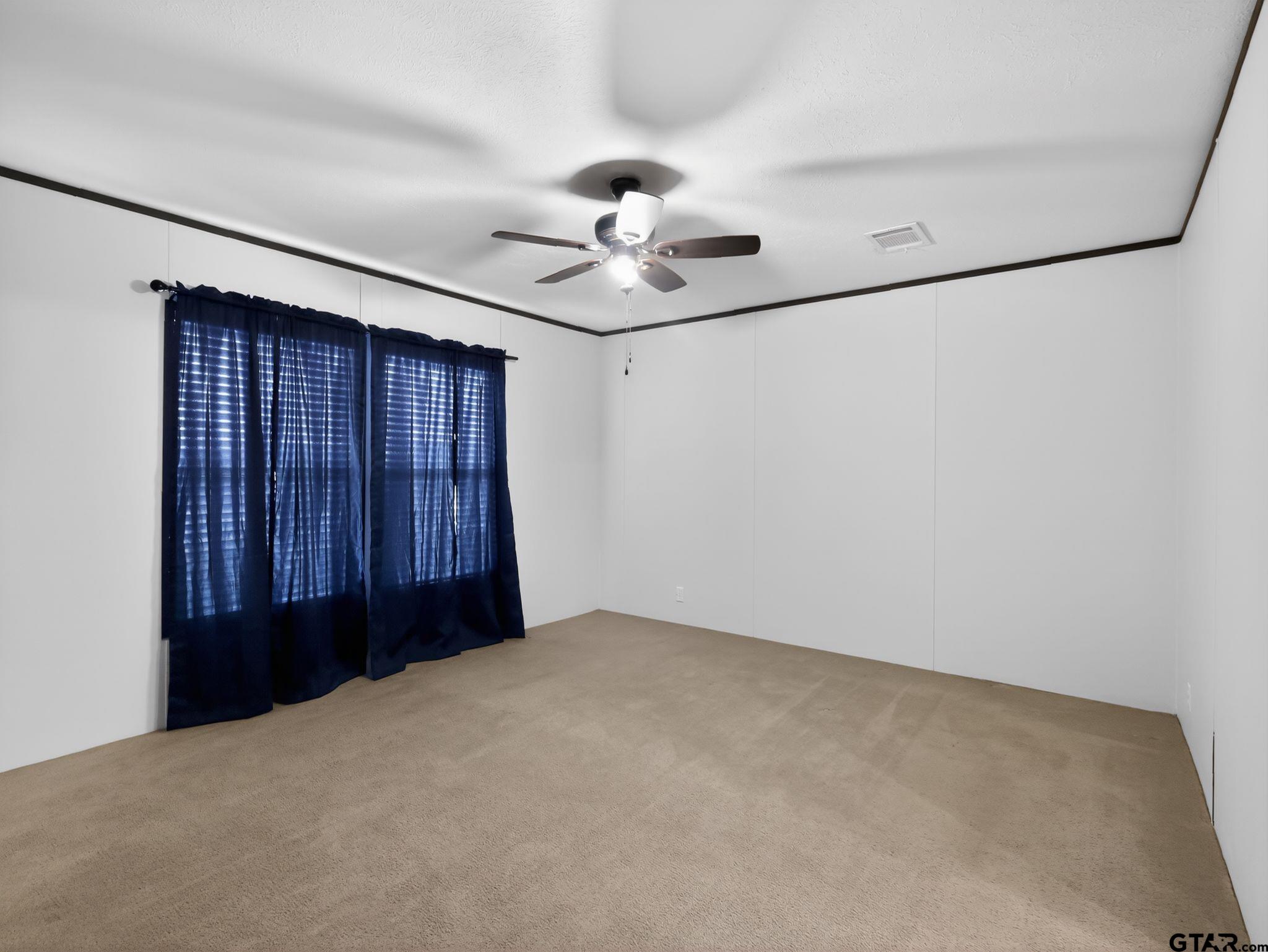 149 Running Bear Quitman, TX 75783 - Photo 17 of 31 a view of a livingroom with a ceiling fan and a chandelier fan