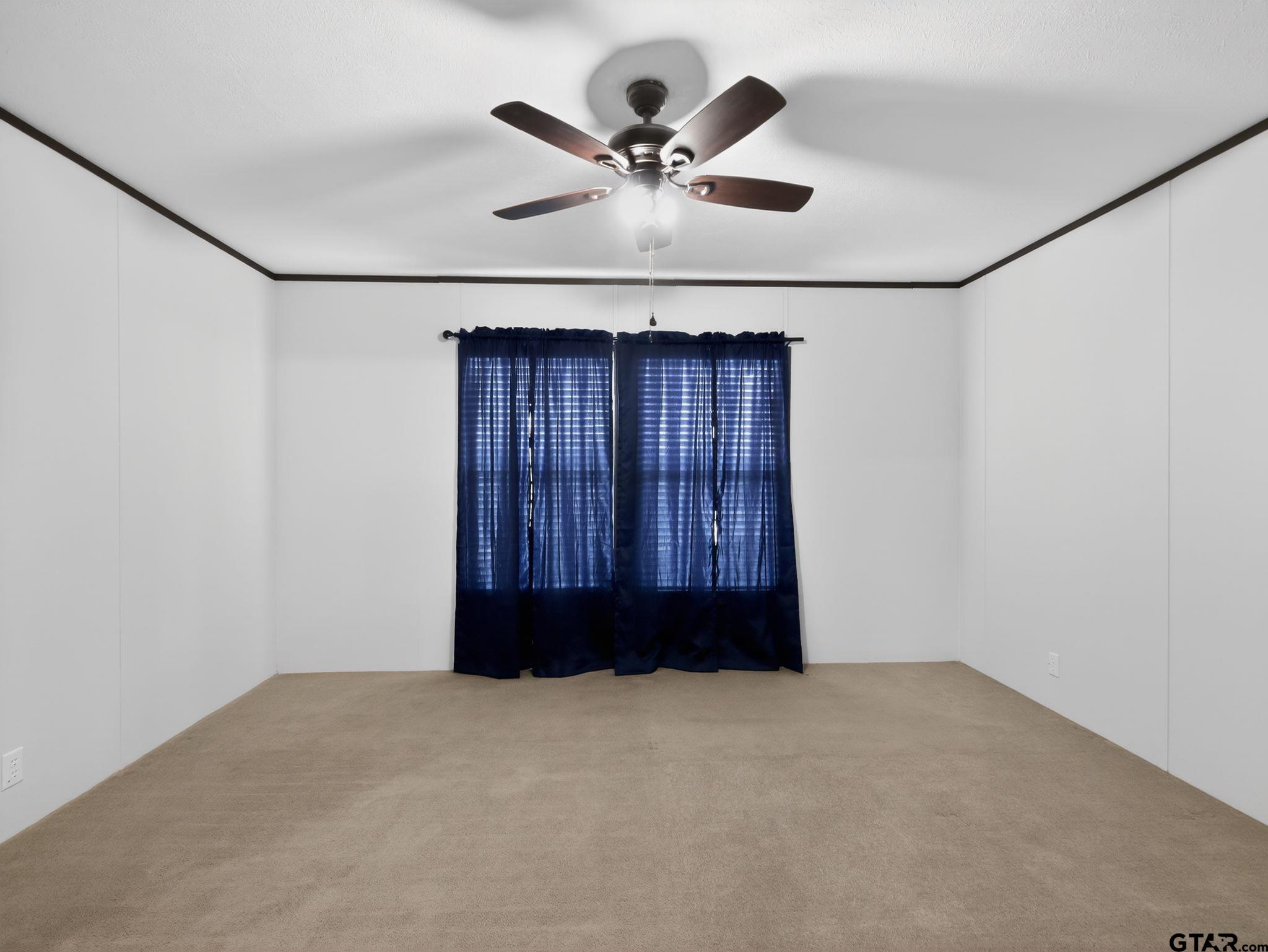 149 Running Bear Quitman, TX 75783 - Photo 19 of 31 an empty room with ceiling fan and window