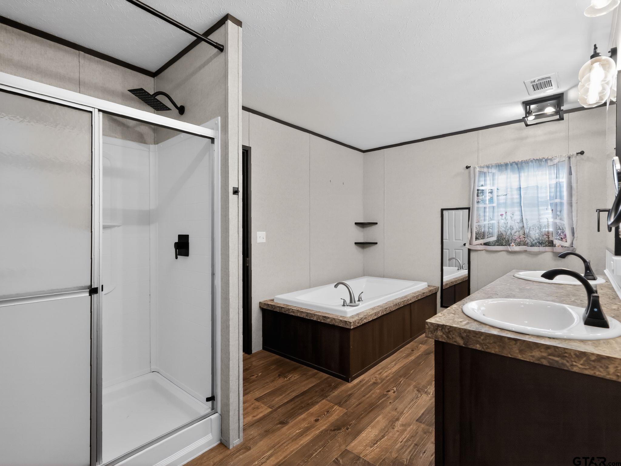 149 Running Bear Quitman, TX 75783 - Photo 20 of 31 a spacious bathroom with a double vanity sink a mirror and shower