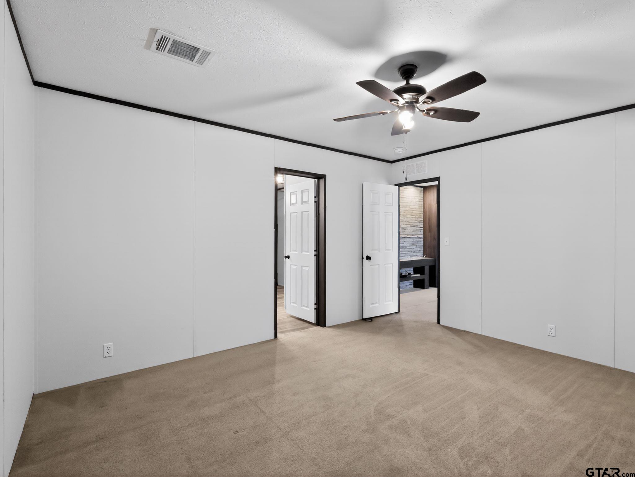 149 Running Bear Quitman, TX 75783 - Photo 20 of 41 a view of an empty room with a ceiling fan