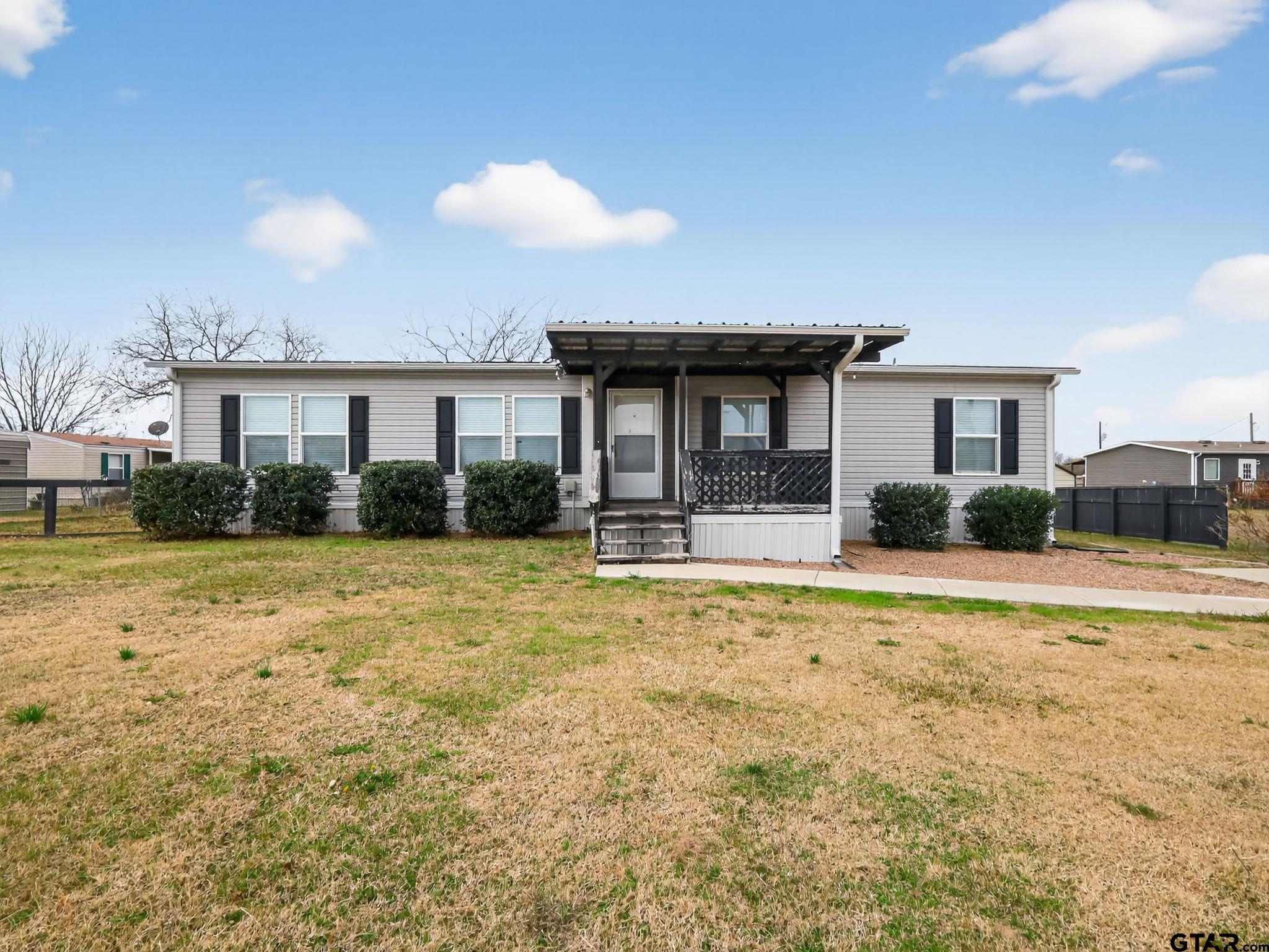 149 Running Bear Quitman, TX 75783 - Photo 2 of 31 a house view with swimming pool and yard