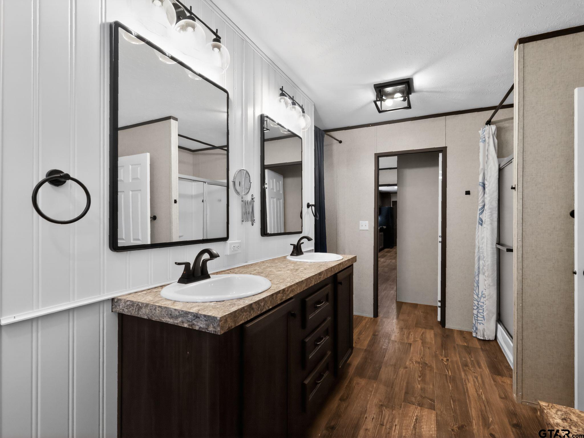 149 Running Bear Quitman, TX 75783 - Photo 22 of 31 a bathroom with a double vanity sink and a mirror