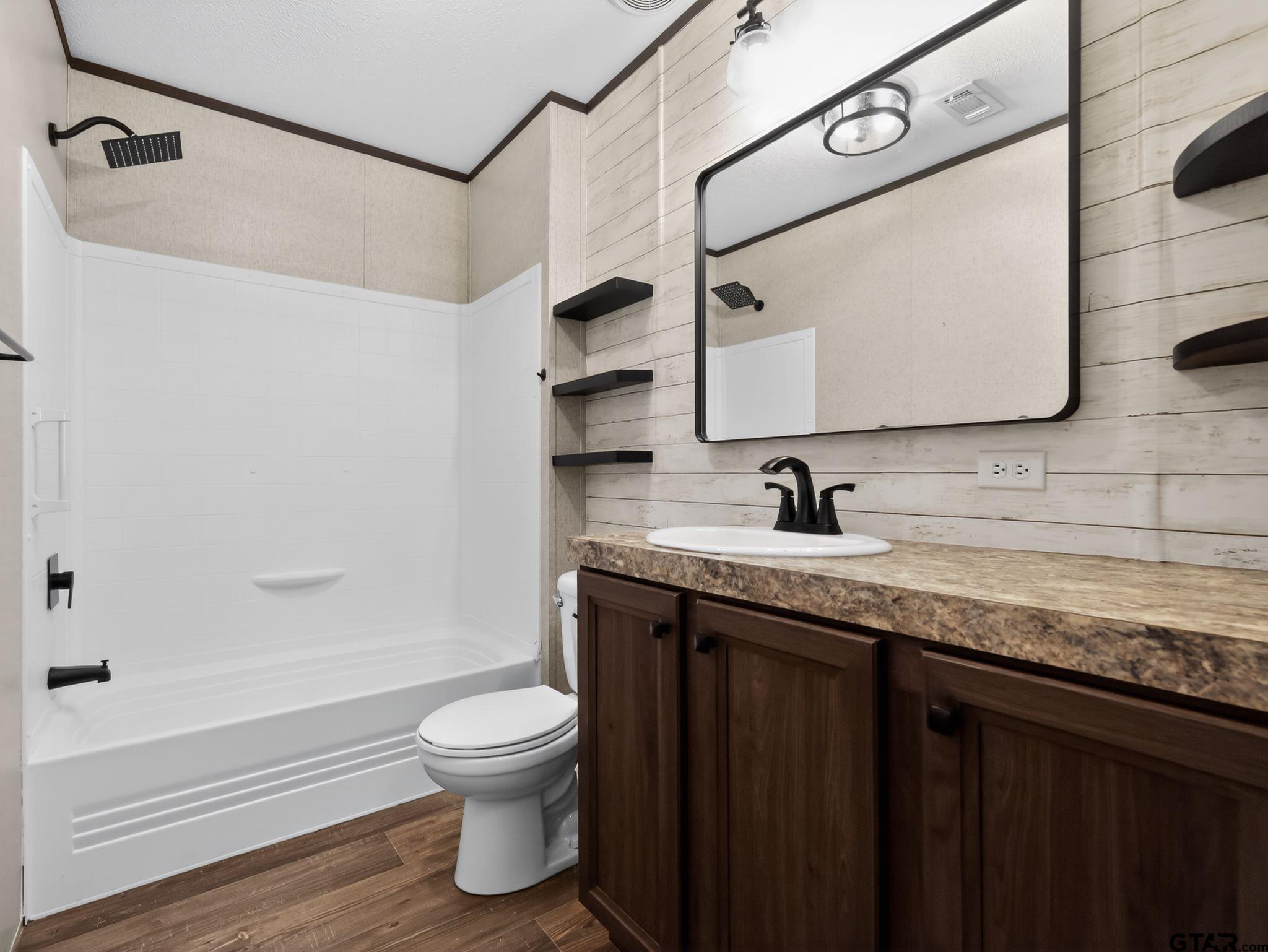 149 Running Bear Quitman, TX 75783 - Photo 25 of 31 a bathroom with a granite countertop sink toilet and shower