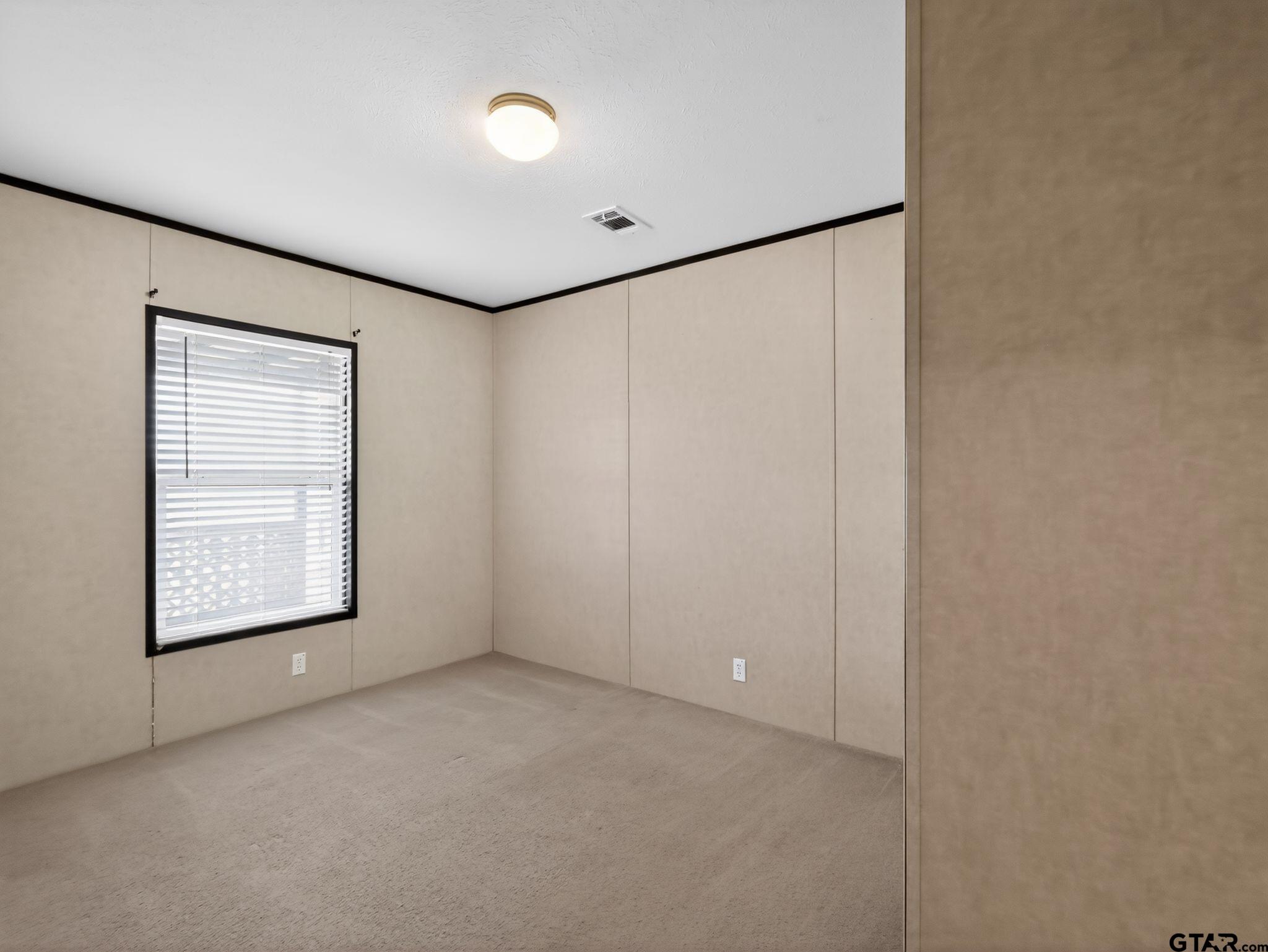 149 Running Bear Quitman, TX 75783 - Photo 28 of 41 an empty room with windows and closet