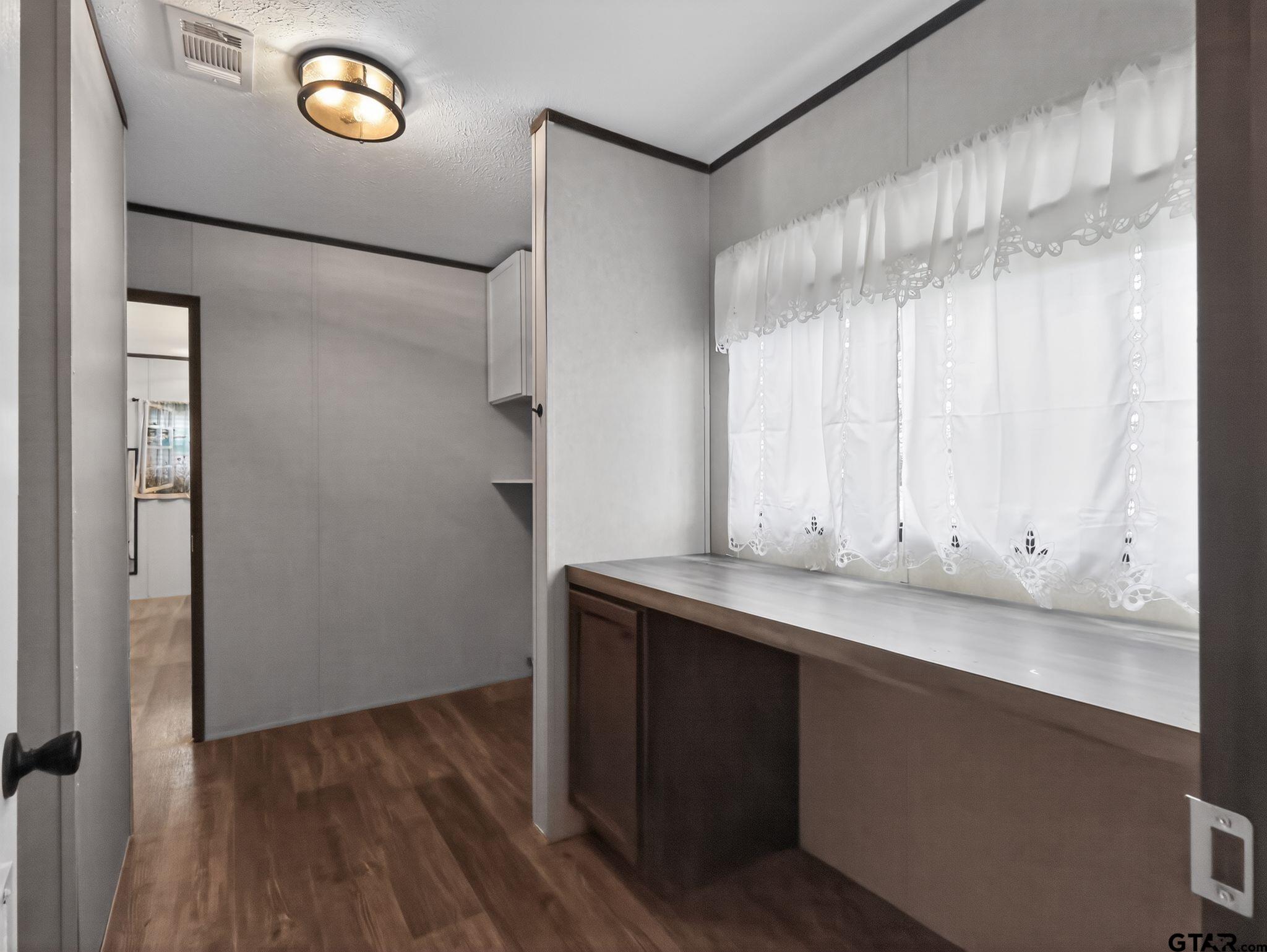 149 Running Bear Quitman, TX 75783 - Photo 29 of 31 a view of cabinets and wooden floor