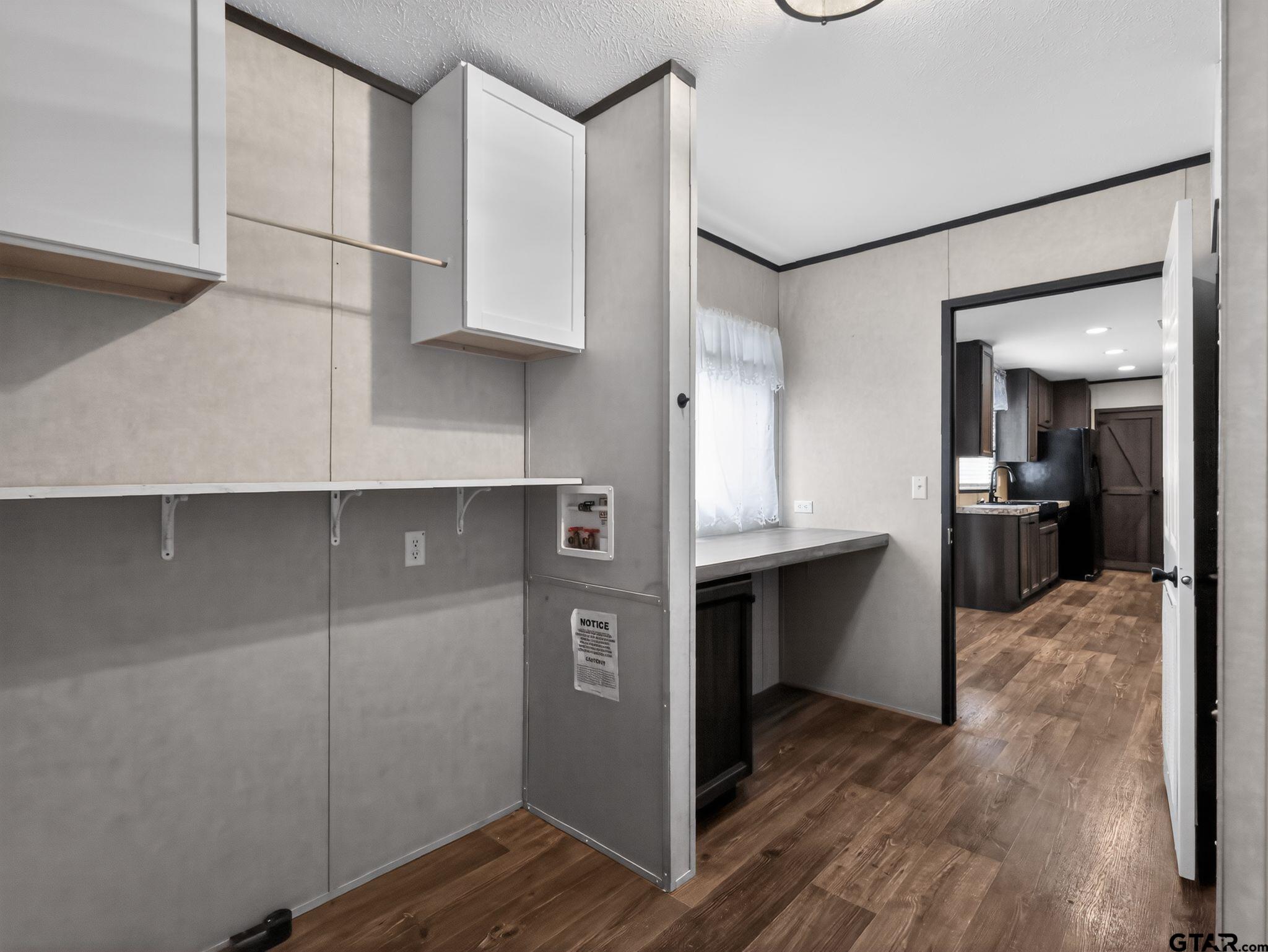 149 Running Bear Quitman, TX 75783 - Photo 30 of 31 a view of kitchen with cabinets and wooden floor