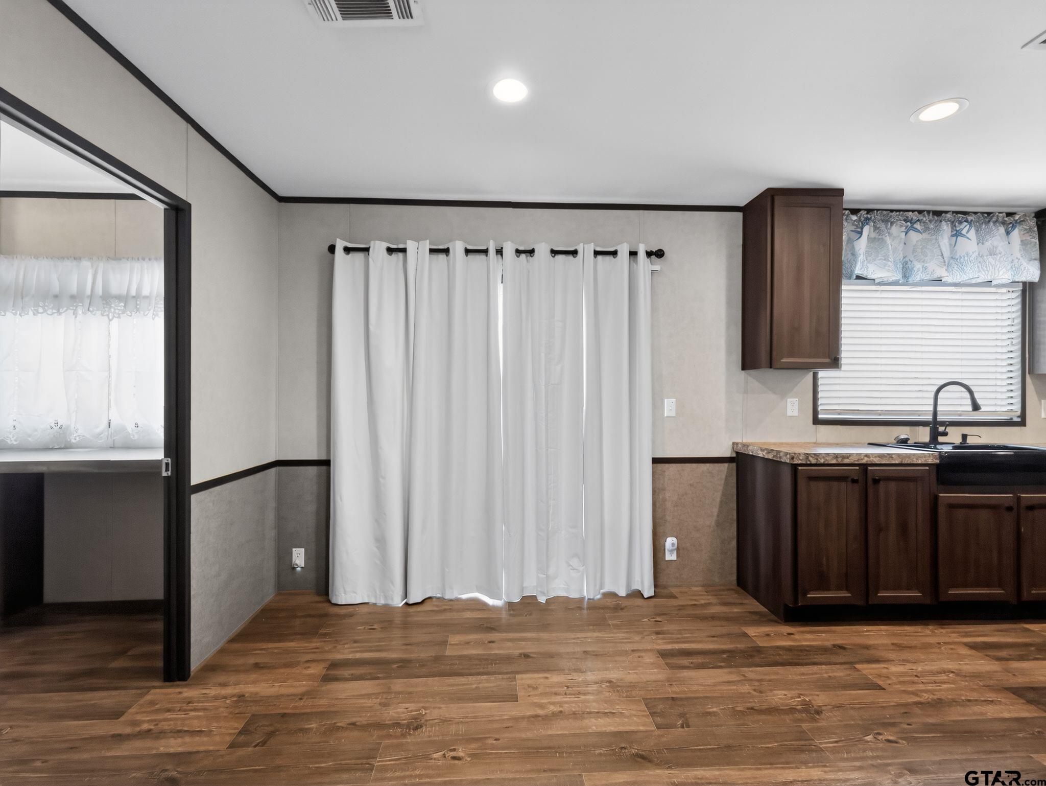 149 Running Bear Quitman, TX 75783 - Photo 10 of 31 a view of a kitchen with a sink and wooden floor