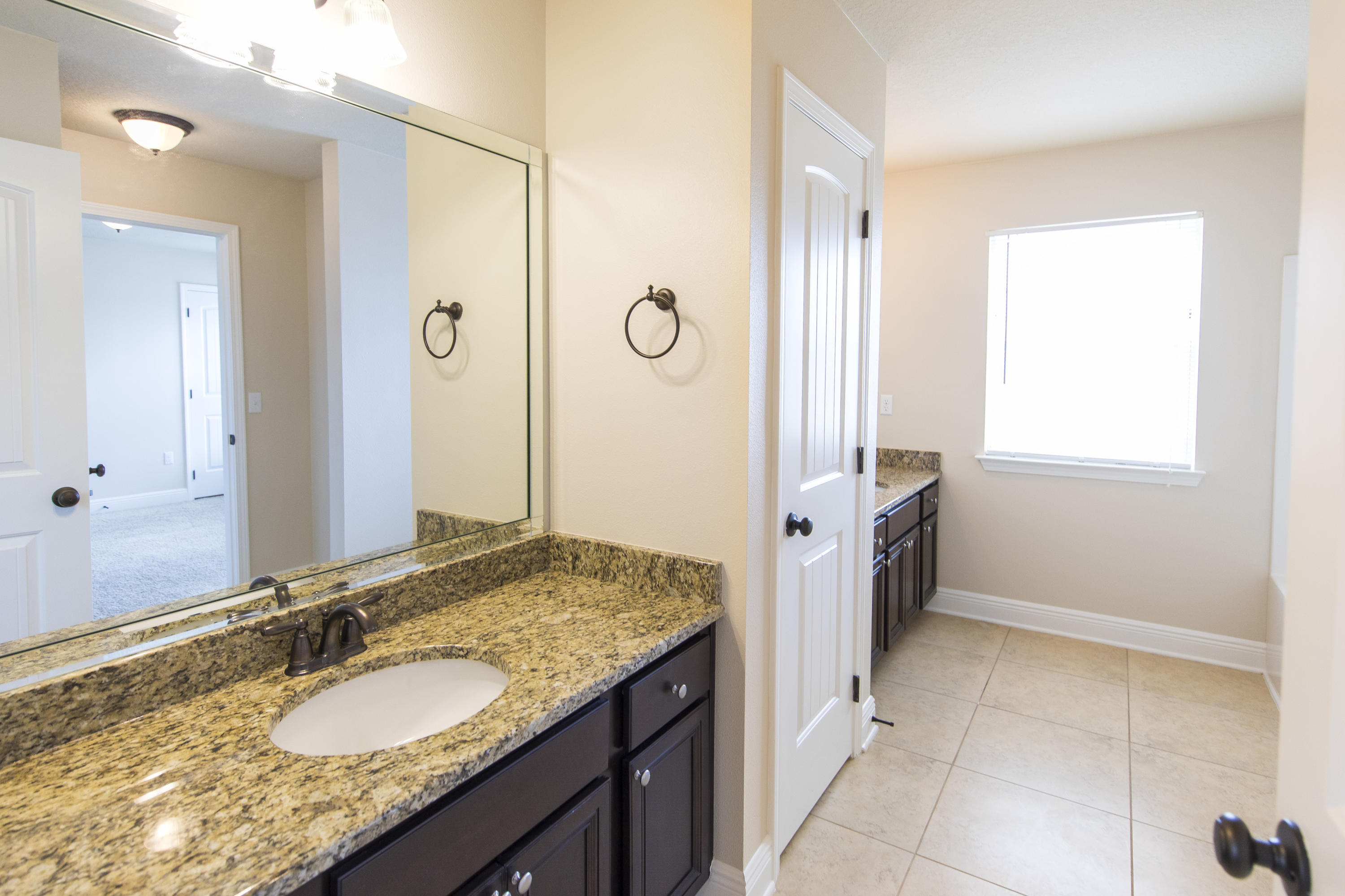 48 Topside Drive Inlet Beach, FL 32461 - Photo 23 of 30 a bathroom with a granite countertop sink a mirror and a bathtub