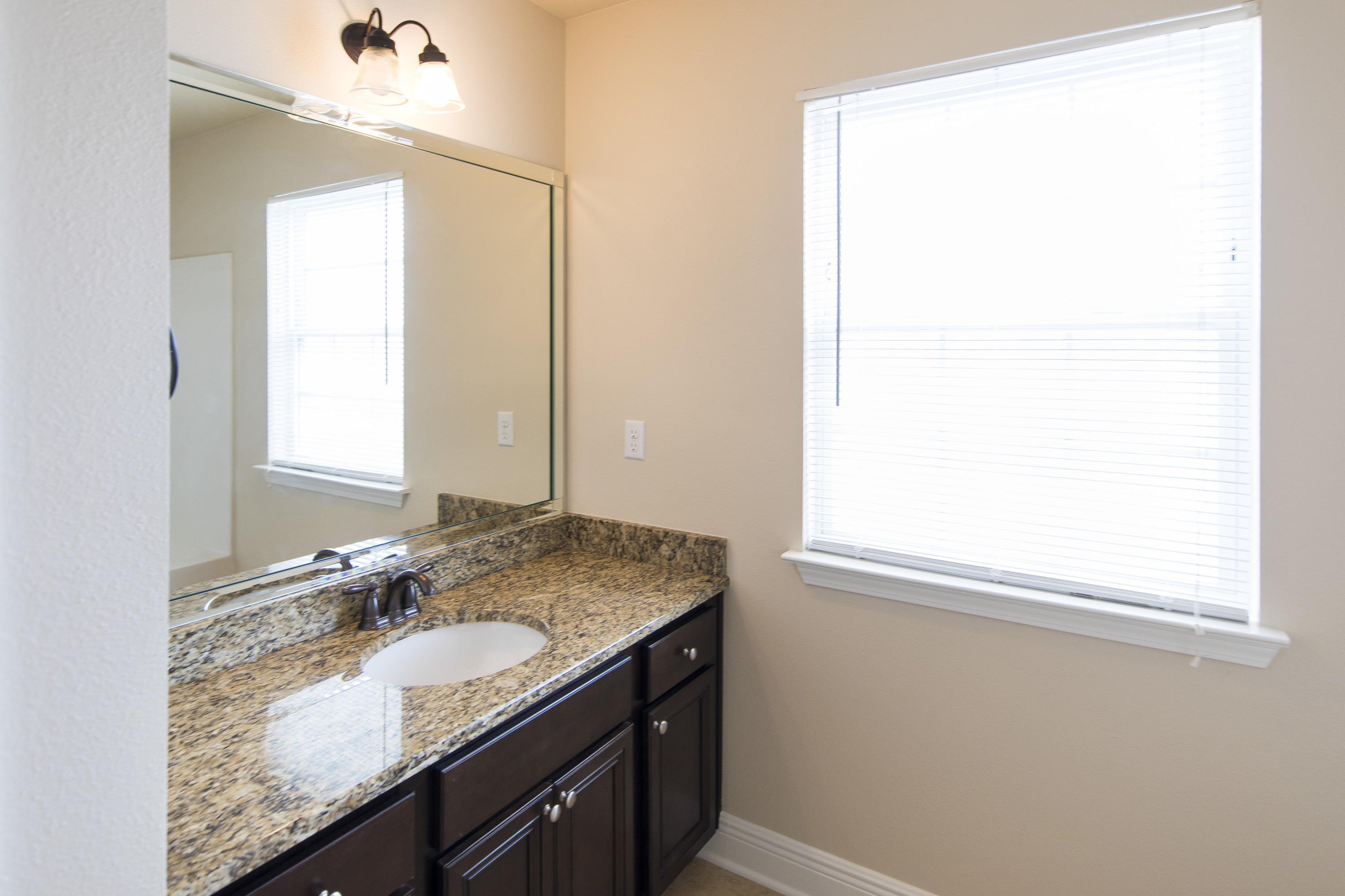 48 Topside Drive Inlet Beach, FL 32461 - Photo 24 of 30 a bathroom with a granite countertop sink and a mirror