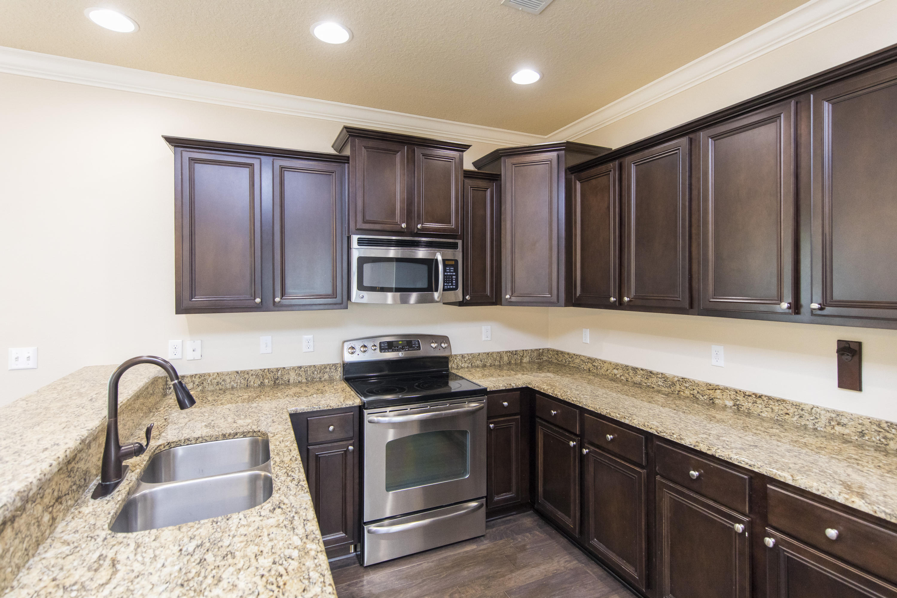 48 Topside Drive Inlet Beach, FL 32461 - Photo 7 of 30 a kitchen with granite countertop wooden cabinets a stove top oven and stainless steel appliances