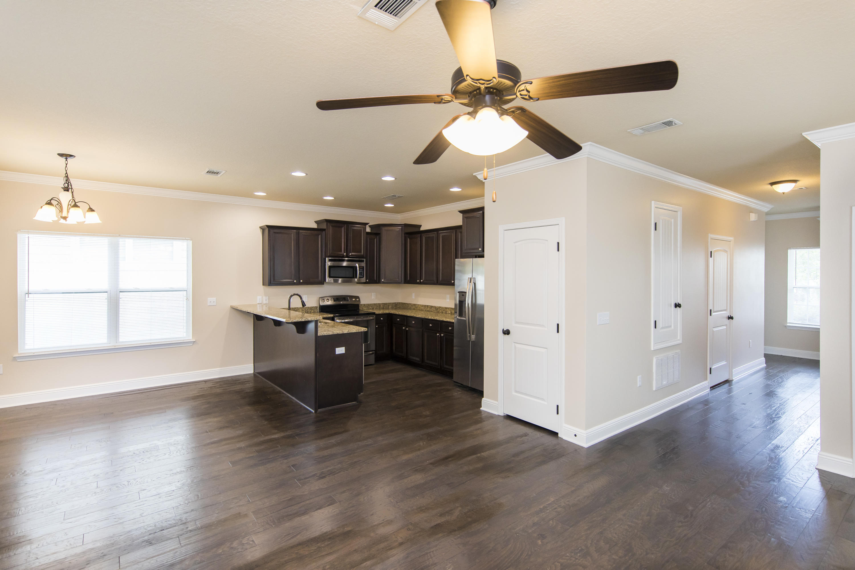 48 Topside Drive Inlet Beach, FL 32461 - Photo 8 of 30 a kitchen with a chandelier stainless steel appliances cabinets and wooden floor