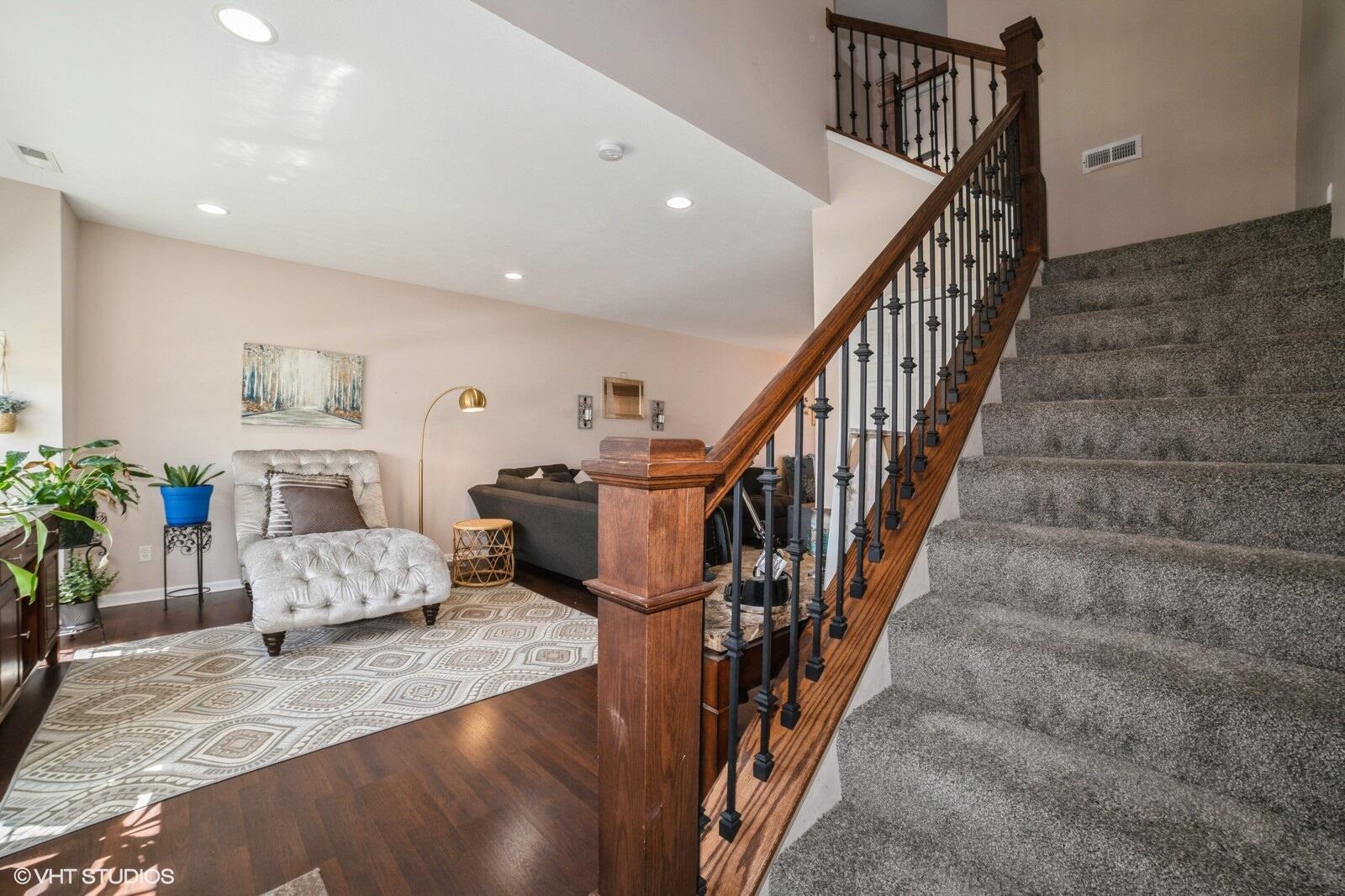 1078 East 114th Avenue Crown Point, IN 46307 - Photo 4 of 20 a living room with furniture and stairs