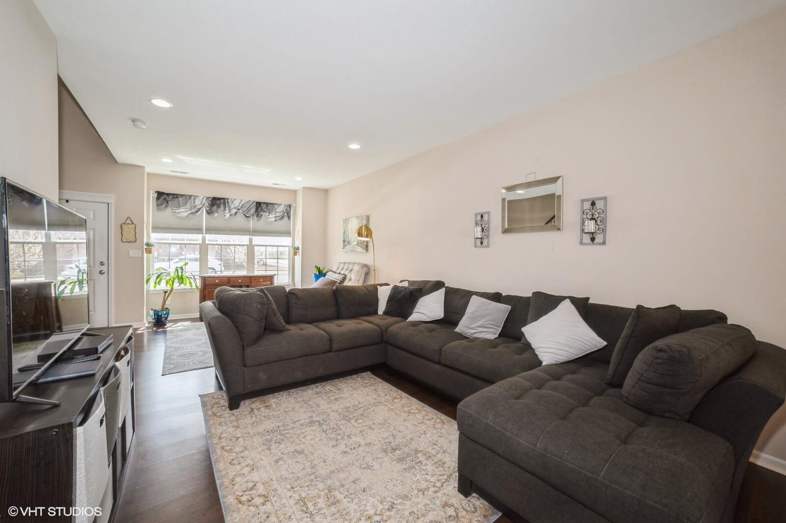1078 East 114th Avenue Crown Point, IN 46307 - Photo 7 of 20 a living room with furniture window and a flat screen tv