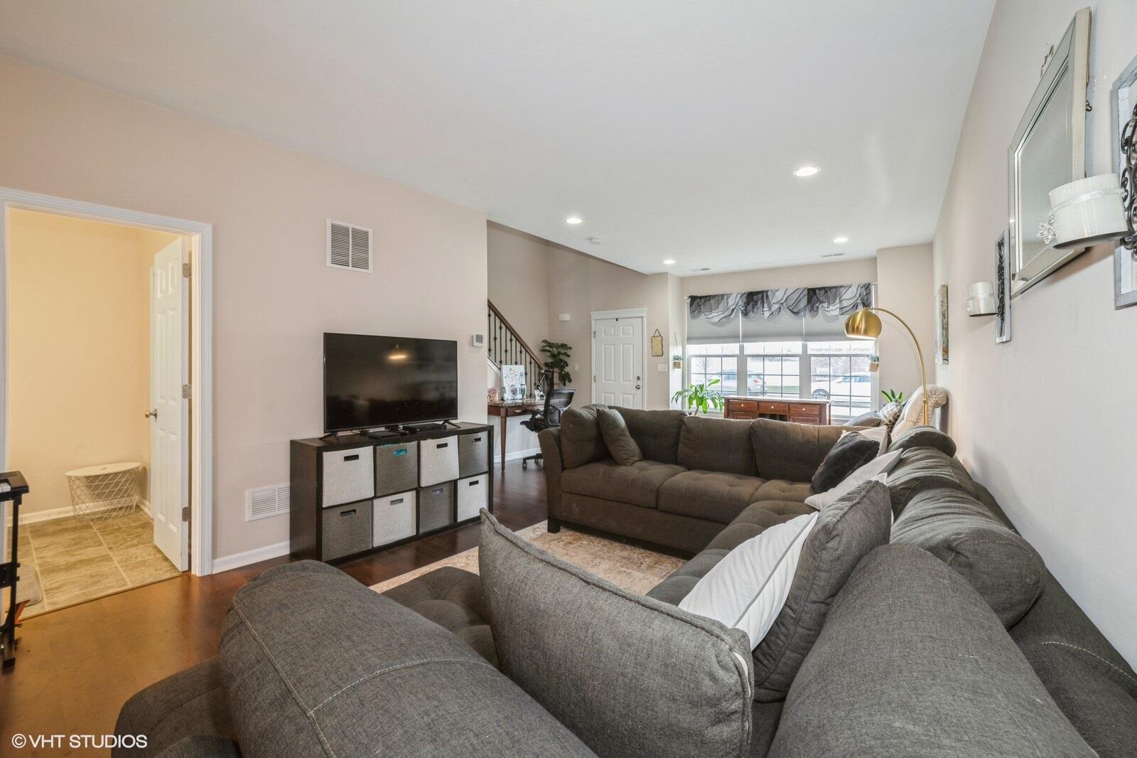 1078 East 114th Avenue Crown Point, IN 46307 - Photo 8 of 20 a living room with furniture and a flat screen tv