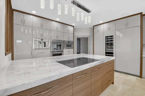 a kitchen with stainless steel appliances granite countertop a sink and refrigerator
