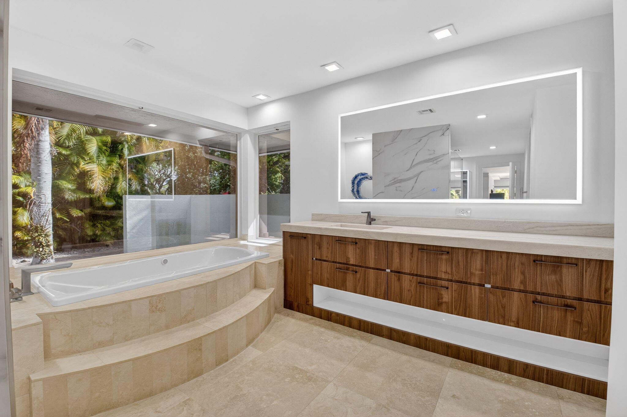 19787 Oakbrook Circle Boca Raton, FL 33434 - Photo 28 of 84 a bathroom with a sink mirror and a bathtub next to a window