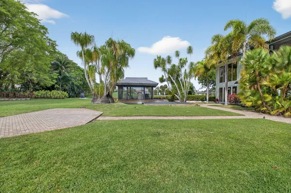 a view of a house with swimming pool and sitting area
