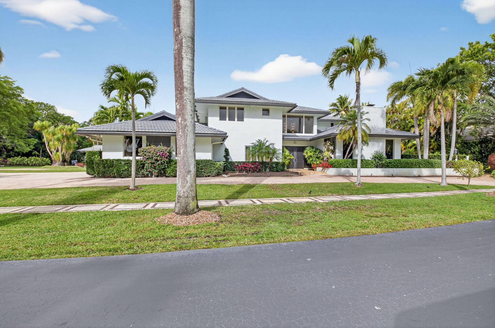 19787 Oakbrook Circle Boca Raton, FL 33434 - Photo 46 of 84 a front view of multi story residential apartment building with yard and green space