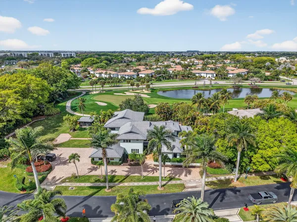an aerial view of residential houses with outdoor space and swimming pool