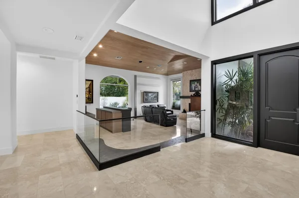 a large room with a large window and stainless steel appliances