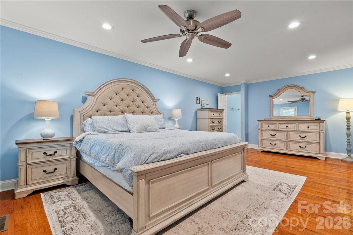 209 Fairway Road Cheraw, SC 29520 - Photo 13 of 48 a spacious bedroom with a bed and a chandelier