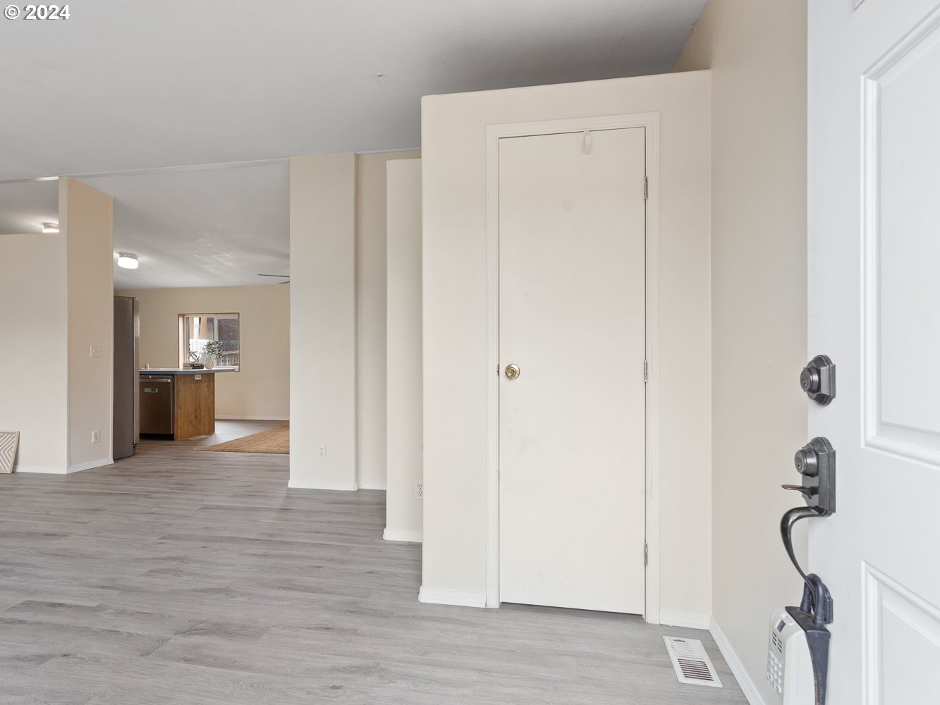 415 Northeast 194th Street, Unit 5 Ridgefield, WA 98642 - Photo 3 of 35 a view of a hallway with wooden floor and a bathroom