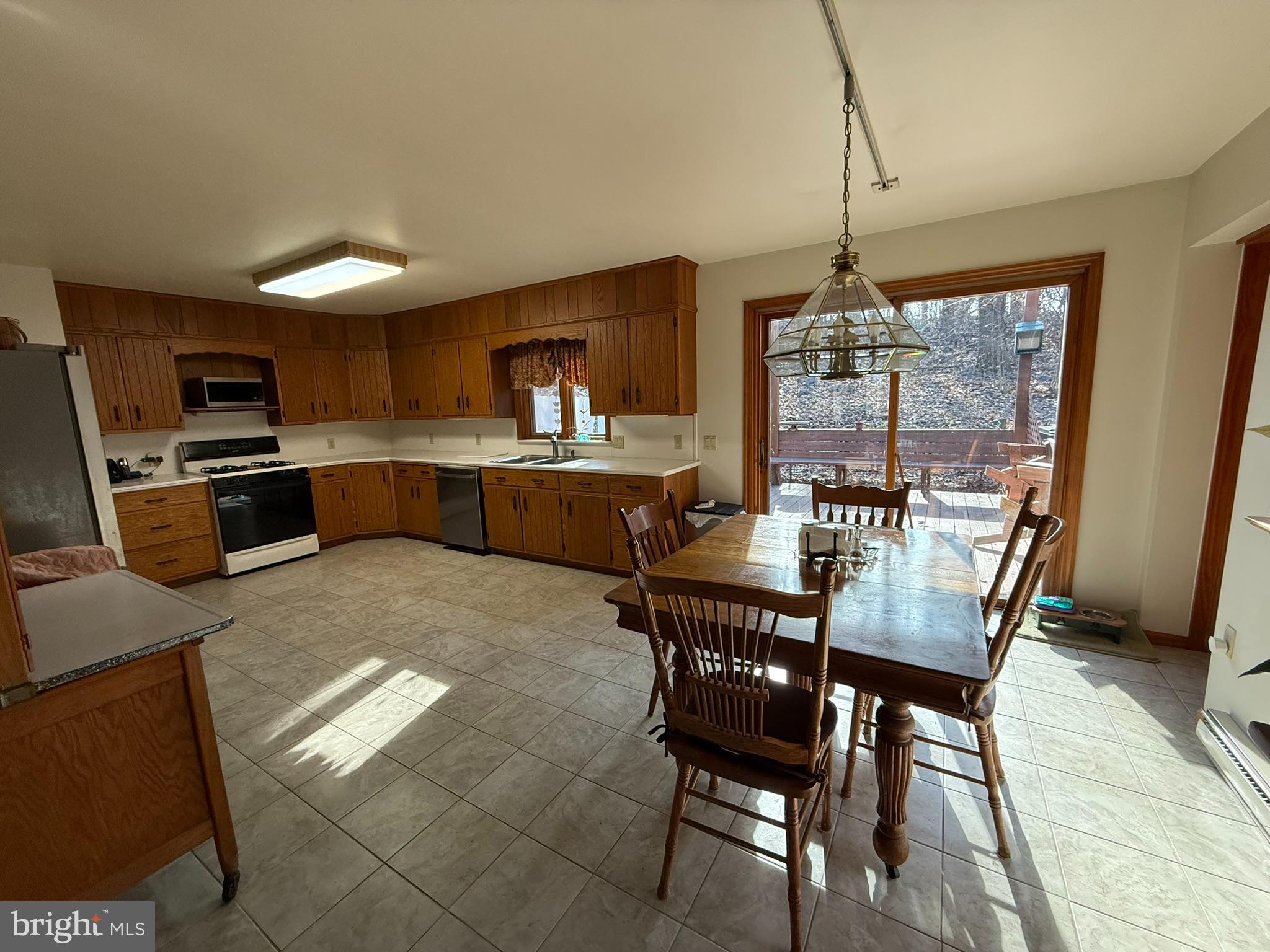 2140 Beaver Dam Road Honey Brook, PA 19344 - Photo 19 of 45 a dining room with furniture a chandelier and wooden floor