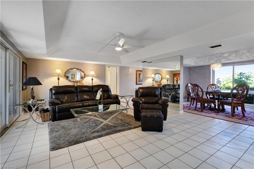 154 Penny Lane, Unit 7 Naples, FL 34112 - Photo 14 of 50 a living room with furniture and wooden floor