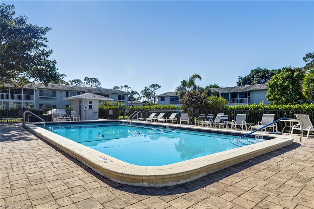 154 Penny Lane, Unit 7 Naples, FL 34112 - Photo 17 of 50 a view of outdoor space and swimming pool