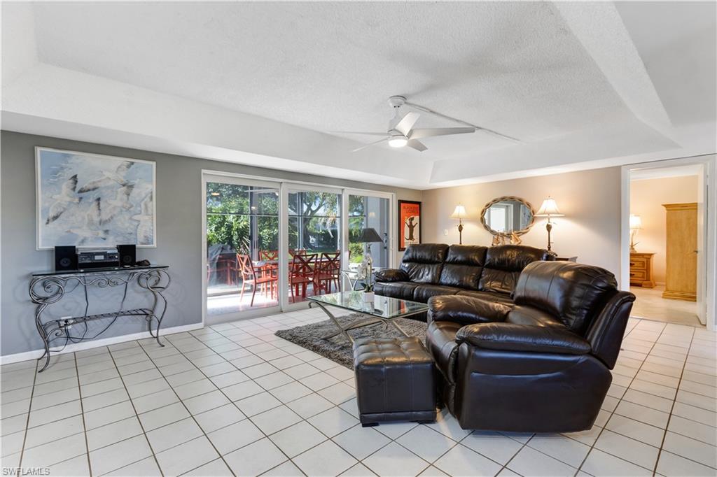 154 Penny Lane, Unit 7 Naples, FL 34112 - Photo 18 of 50 a living room with furniture and a large window