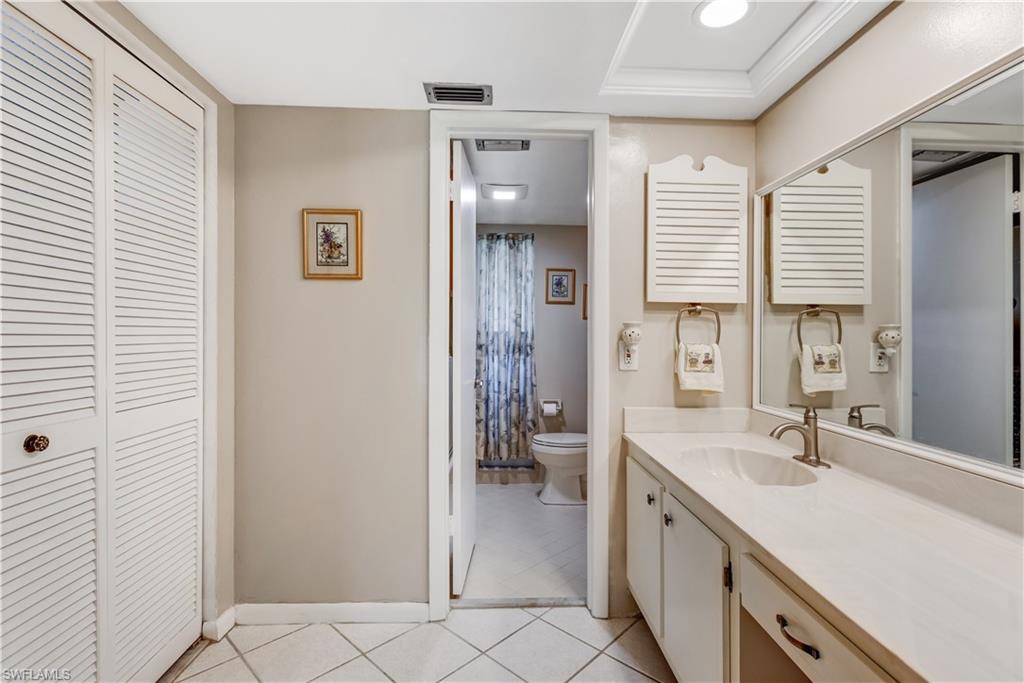 154 Penny Lane, Unit 7 Naples, FL 34112 - Photo 21 of 50 a spacious bathroom with a double vanity sink a mirror and a shower