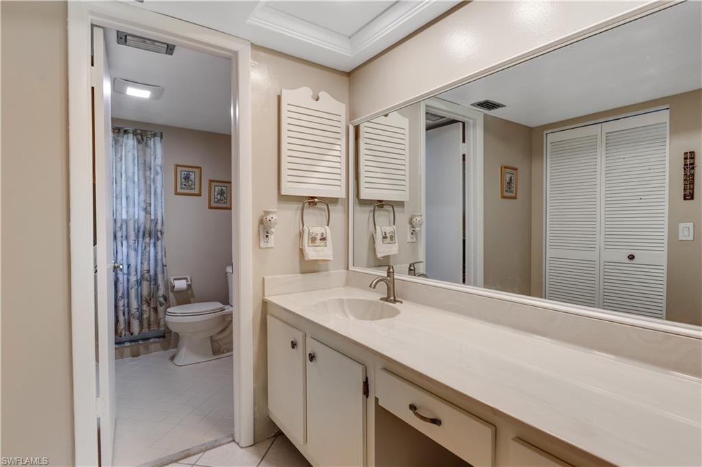 154 Penny Lane, Unit 7 Naples, FL 34112 - Photo 22 of 50 a bathroom with a sink a toilet and shower