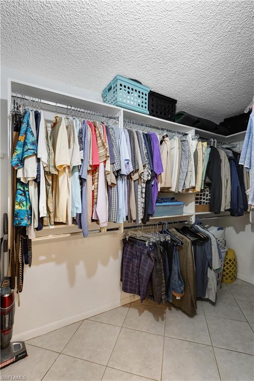 154 Penny Lane, Unit 7 Naples, FL 34112 - Photo 24 of 50 a view of walk in closet with clothes
