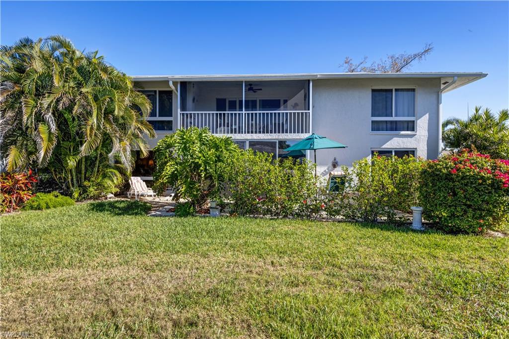 154 Penny Lane, Unit 7 Naples, FL 34112 - Photo 34 of 50 a front view of a house with garden