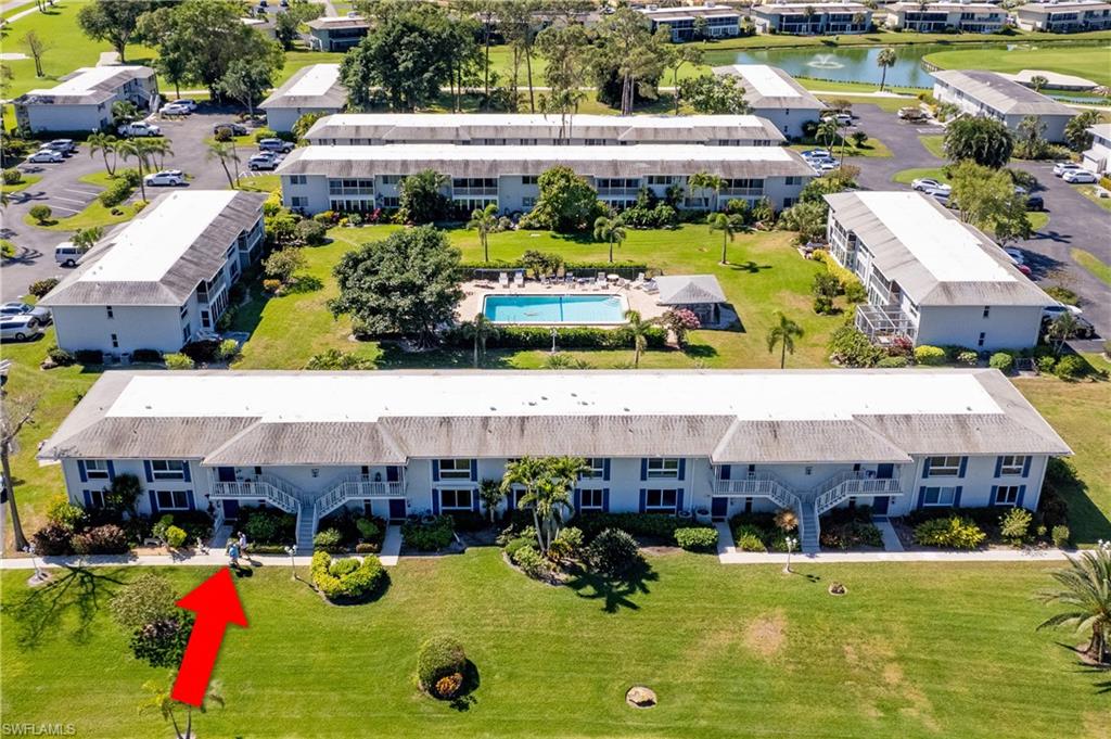 154 Penny Lane, Unit 7 Naples, FL 34112 - Photo 35 of 50 a aerial view of a house with swimming pool and outdoor seating