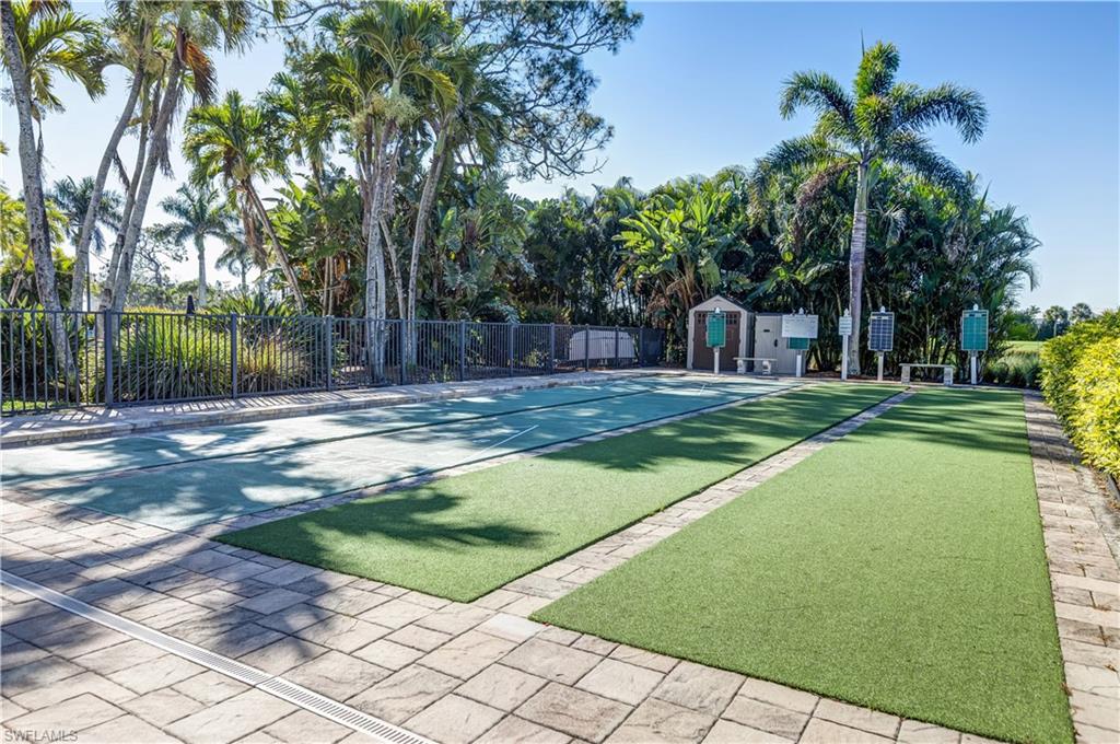 154 Penny Lane, Unit 7 Naples, FL 34112 - Photo 39 of 50 a backyard of a house with table and chairs