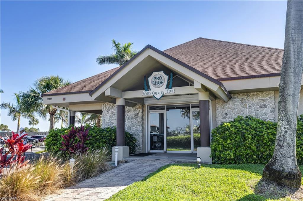 154 Penny Lane, Unit 7 Naples, FL 34112 - Photo 42 of 50 a front view of a house with garden