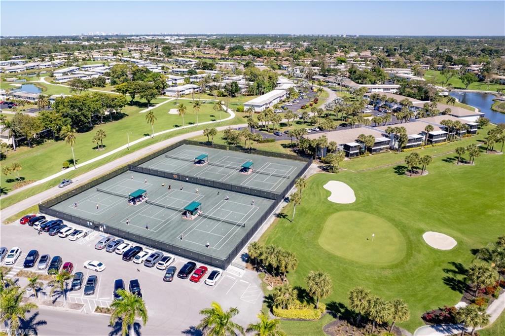 154 Penny Lane, Unit 7 Naples, FL 34112 - Photo 43 of 50 an aerial view of a residential houses with outdoor space