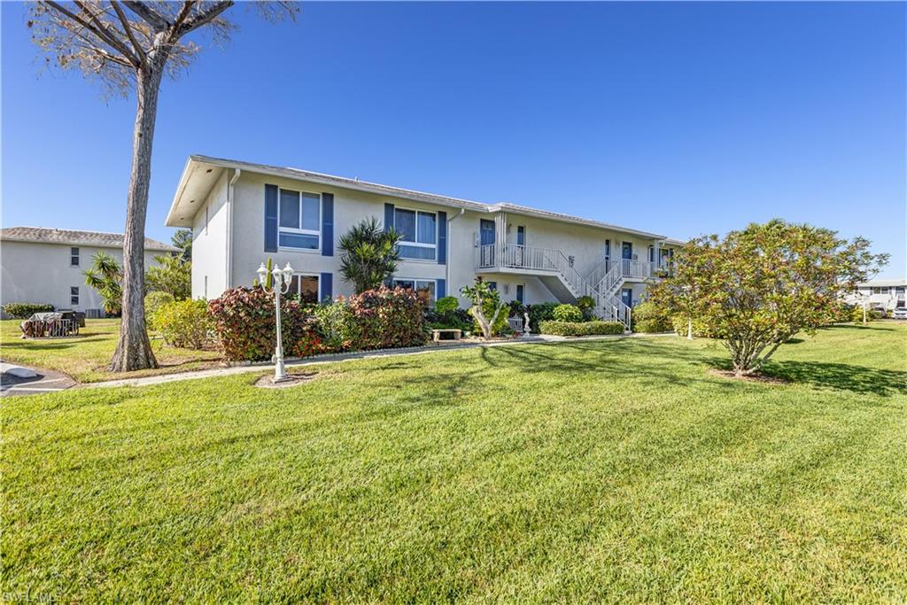 154 Penny Lane, Unit 7 Naples, FL 34112 - Photo 49 of 50 a view of a house with backyard and sitting area