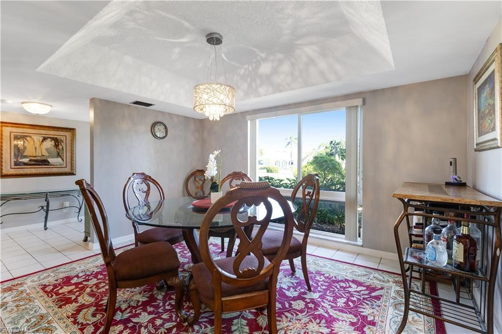154 Penny Lane, Unit 7 Naples, FL 34112 - Photo 5 of 50 a view of a dining room and hall with furniture