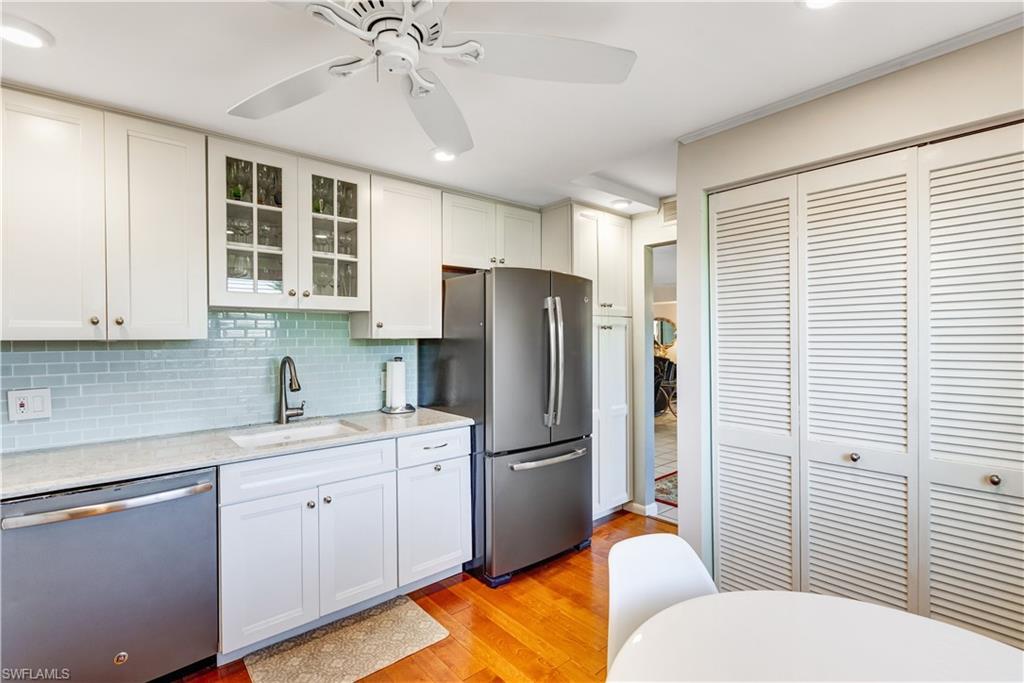 154 Penny Lane, Unit 7 Naples, FL 34112 - Photo 9 of 50 a kitchen with stainless steel appliances a refrigerator sink and cabinets