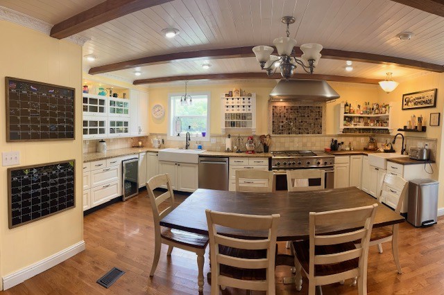 7470 Smith Chapel Road Cookeville, TN 38501 - Photo 13 of 70 a kitchen with a stove a sink a dining table and chairs