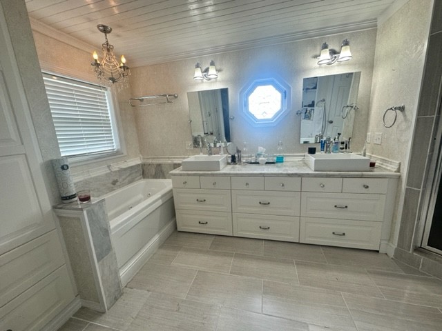 7470 Smith Chapel Road Cookeville, TN 38501 - Photo 18 of 70 a spacious bathroom with a granite countertop sink a mirror a vanity a window and a bathtub