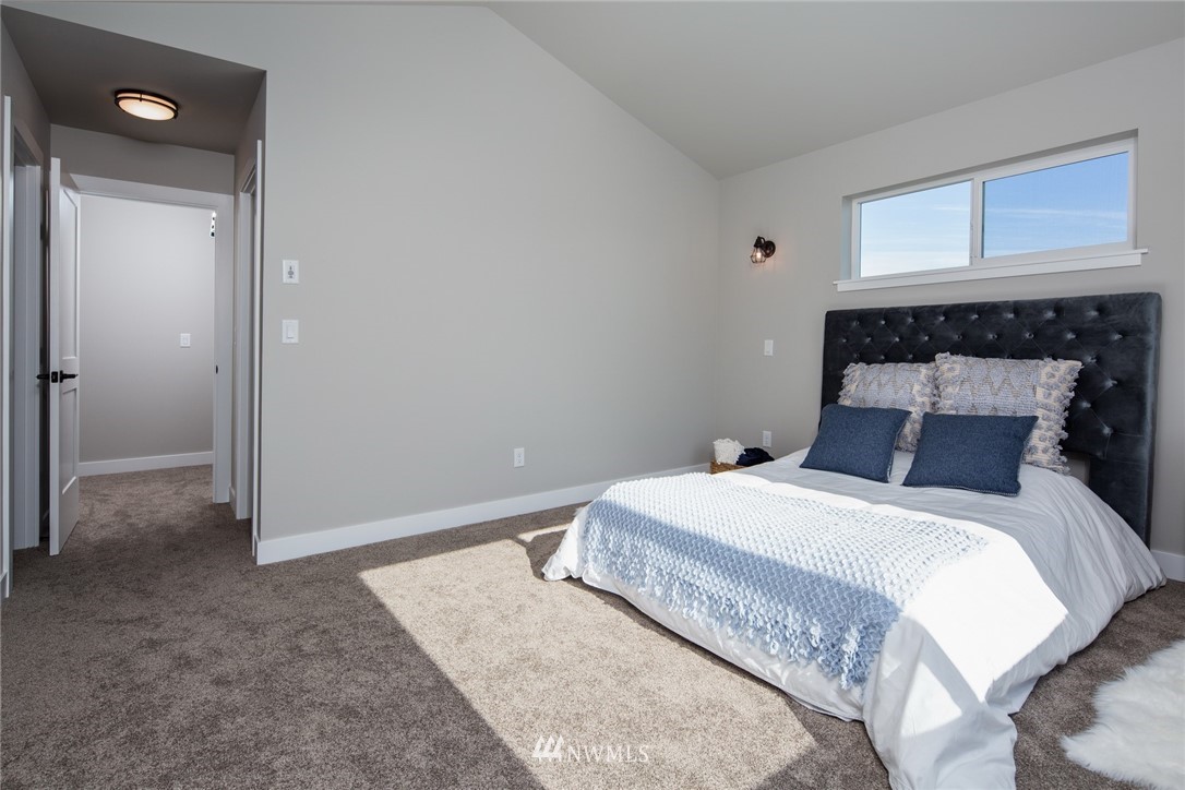 5572 South Church Road Ferndale, WA 98248 - Photo 13 of 30 a bedroom with a bed and a fireplace