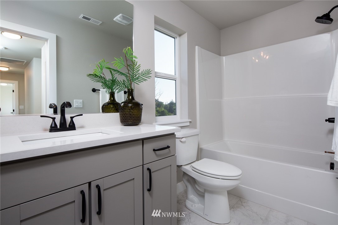5572 South Church Road Ferndale, WA 98248 - Photo 15 of 30 a bathroom with a toilet a sink and a bathtub