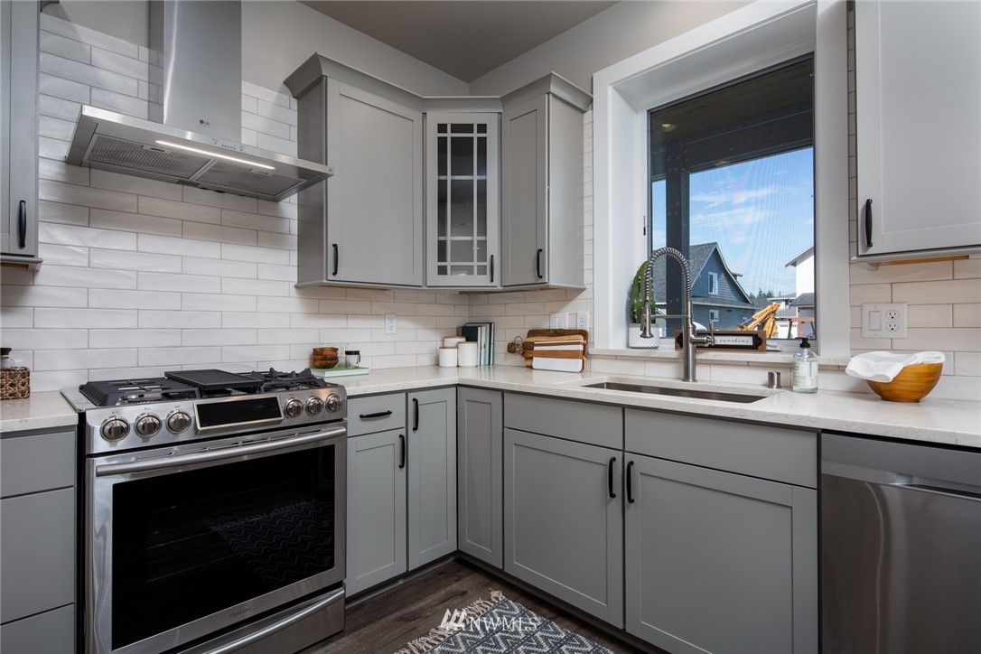 5572 South Church Road Ferndale, WA 98248 - Photo 6 of 30 a kitchen with a sink stove and cabinets