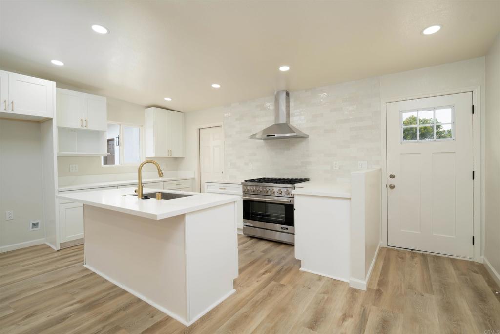 1314 Bluegrass Road Vista, CA 92083 - Photo 4 of 16 a kitchen with stainless steel appliances a sink stove and cabinets
